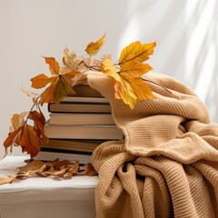 blanket near books and leaves on wihte background