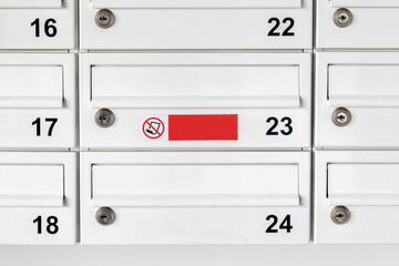 Simple communal letterboxes, post box letter boxes for flat apartments front view object detail closeup, nobody, no advertisements sticker label. Numbered apartment postbox up close, frontal shot