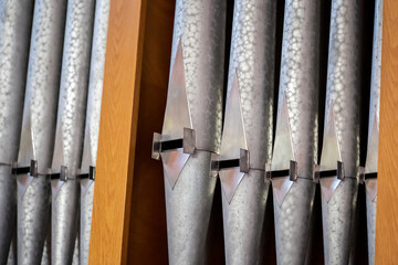 Pipe organ metal pipes in a row up close detail nobody. Religious music service, pipe organ musical...