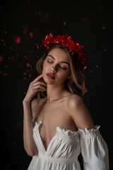 A blushing bride adorned in a stunning headpiece with red bows, exuding grace and elegance in her beautiful wedding dress during an intimate indoor photo shoot