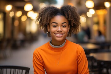 Naklejka premium beautiful afroamerican woman with bright clear eyes with wireless headphones ,wearing casual dress