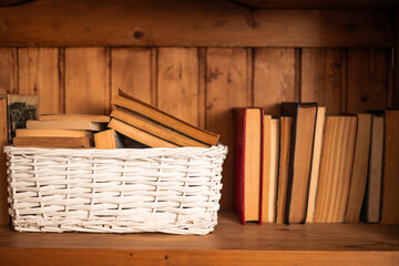 old books kept in a white wicker basket world book day
