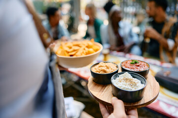 Close up of waiter serving food while working in restaurant.