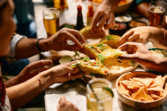 Close up of friends having Mexican food for lunch in restaurant.