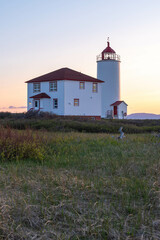 Fototapeta na wymiar The Lighthouse of L’Isle-Verte at the sunset (Notre-Dame-des-Sept-Douleurs, L’Isle-Verte, Quebec, Canada)