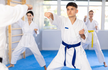 Fighting stance of men and women during group karate training