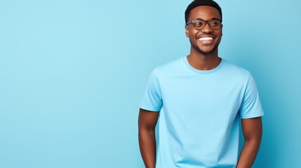 Attractive african american man wearing blue tshirt and glasses. Isolated on blue background. - obrazy, fototapety, plakaty