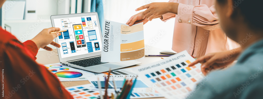 Poster cropped image of interior designer team presents color by using color swatches while laptop displaye