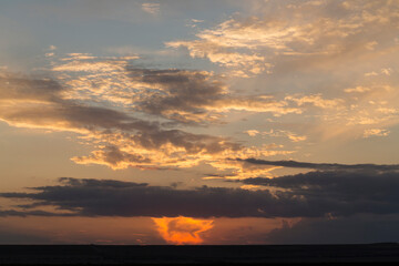 Landscape at sunset. Tragic gloomy sky. Panorama. Crimson twilight.
