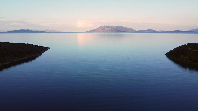 This footage was made with a drone, near the Ancient Epidaurus town during sunset, with the sea, sailboats and the town in the frame