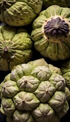 Obraz premium A close-up view of a group of ripe, vivid Cherimoya with a deep, textured detail.