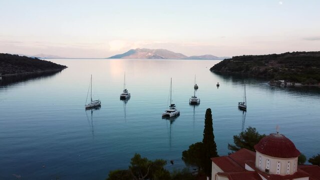 This footage was made with a drone, near the Ancient Epidaurus town during sunset, with the sea, sailboats and the town in the frame