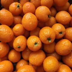 A close-up view of a group of ripe, vivid Kumquat with a deep, textured detail.