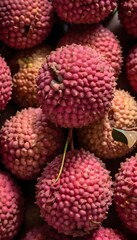 A close-up view of a group of ripe, vivid Lychee with a deep, textured detail.