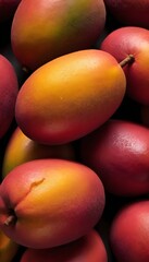 A close-up view of a group of ripe, vivid Mango with a deep, textured detail.