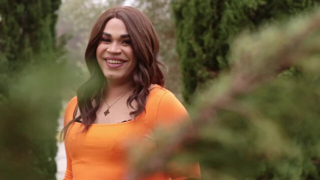 Transsexual woman smiling to the camera. Park outdoors.