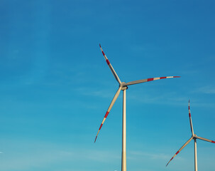 Wind farm park next to a road in Austria in sunny weather.