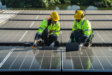 Worker Technicians are working to construct solar panels system on roof. Installing solar photovoltaic panel system. Alternative energy ecological concept. Renewable clean energy technology concept.