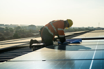 Worker Technicians are working to construct solar panels system on roof. Installing solar...