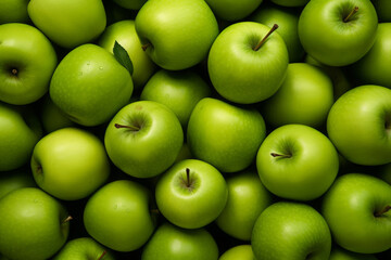 Fresh green apples filling the entire frame with droplets of water glistening, food background, overhead shot