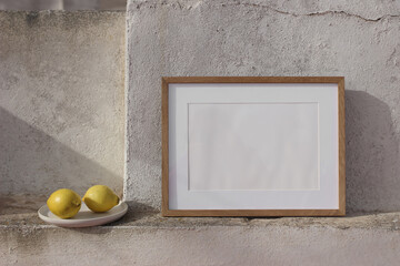 Blank horizontal wooden picture frame mockup against white old textured shabby white wall. Fresh...