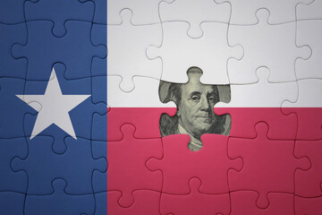 puzzle with the national flag of texas state and usa dollar banknote. finance concept