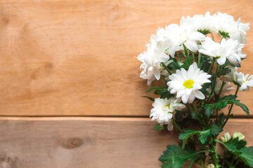 Bouquet of white flowers on wooden background. Flat lay, top view, copy space