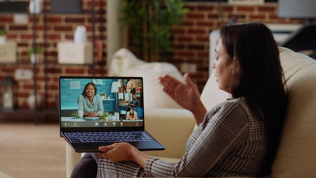 Indian remote employee talks with board of directors during videocall business meeting from cozy apartment. Teleworker speaks in teleconference call, receiving project tasks feedback from management