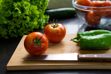 Healthy food. Vegetarian Food. Fresh and organic tomatoes, lettuce, peppers, cucumbers in a delicious salad