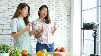 Two Asian influencer vlogger live review healthy lifestyle together. Two Young Women Friends...