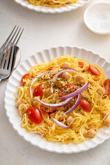 Spaghetti squash with chickpeas and tomatoes topped with red onion, low carb vegan recipe idea