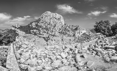 Termessos Amphitheater ruins on the south west side of the mountain Solymos in the Taurus Mountains Antalya province, Turkey in black and white - 733508699