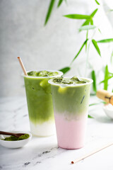 Iced matcha latte and strawberry milk matcha latte in tall glasses with ice