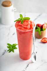 Strawberry watermelon smoothie or slushie in a tall cup