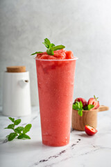 Strawberry watermelon smoothie or slushie in a tall cup