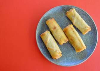 Delicious cheeseburger spring rolls on a plate in the kitchen.