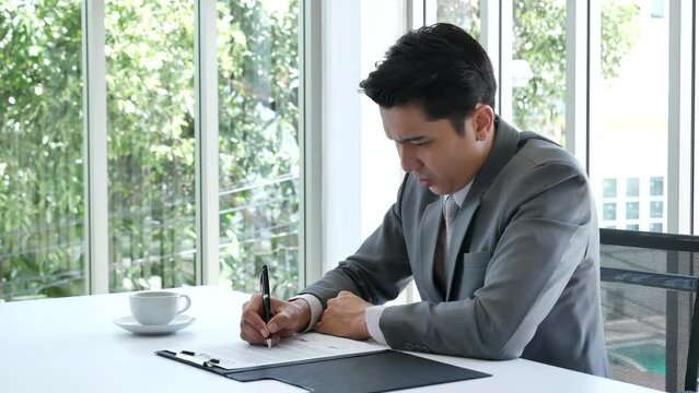 Asian business man using pen signing on new contract to starting projects in conference room. Close up manager businessman hands sign contract working meeting. Business agreement concepts
