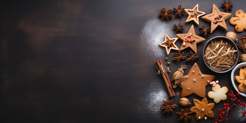 Christmas gingerbread cookies and spices on dark wooden background, copy space