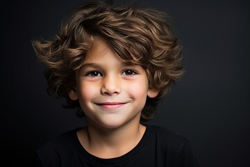 Portrait of a cute little boy with curly hair over black background - Powered by Adobe