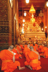 Buddha image and monks in Wat Pho Temple, Bangkok, Thailand