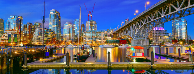 Boat docked in Granville island near Burrard Street Bridge at twilight in Vancouver, Canada