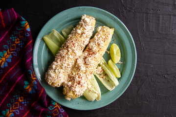 Mexican snack; Elotes with mayonnaise, cheese and chili powder