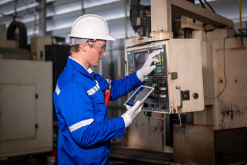Industry engineer worker wearing safety uniform control operating computer controlled Lathe...