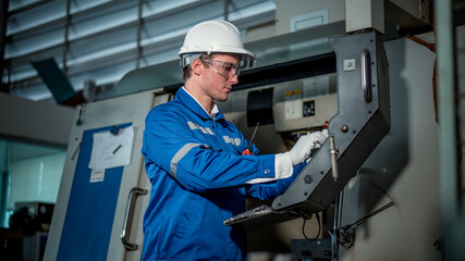 Industry engineer worker wearing safety uniform control operating computer controlled Lathe...