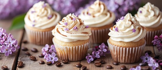 A variety of cupcakes with white frosting and purple flowers displayed on a wooden table, showcasing a delightful dessert made with baked goods and cake decorating supplies.