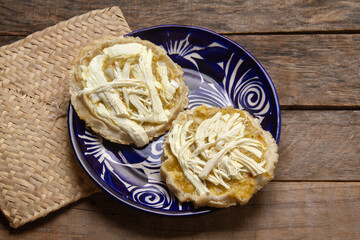 Flavorful Delight: Sopes with green sauce, cheese, and onion