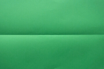 Folded green color paper for background.