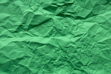 Green color crumpled paper for background.