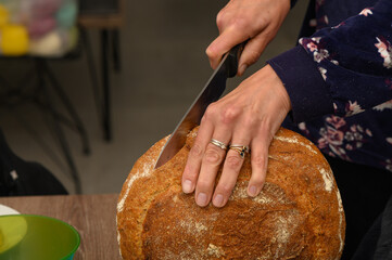 woman cutting a loaf of freshly baked homemade bread 3
