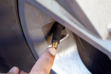 your finger presses the nipple on the wheel